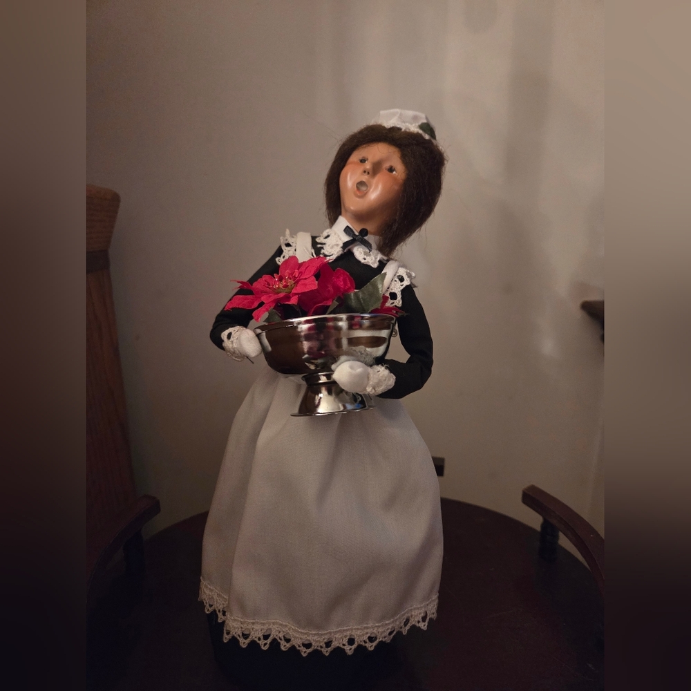 Festive Caroler Figurine with Silver Bowl and Red Flowers